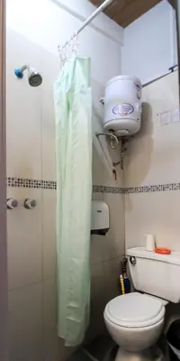 a small bathroom with a toilet and a shower at Mini Apartment Flat in the heart of Cusco - Close to Main Square in Cusco