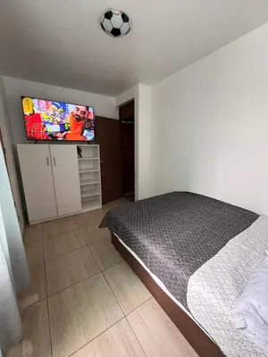 a bedroom with a bed with a soccer ball on the tv at Departamento Playa El Silencio in Punta Hermosa