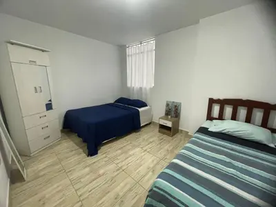 a bedroom with two beds and a dresser at Casa pulpos in Punta Hermosa