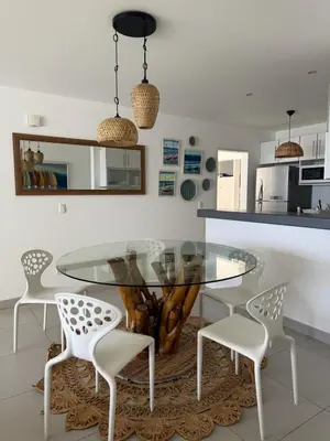 a dining room with a glass table and chairs at Oceanfront apartment con opcion de Velero in Paracas