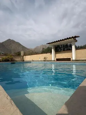a swimming pool with a gazebo at Casa de campo Rosenthal - Cieneguilla in Panquilma