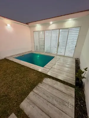 a swimming pool in the backyard of a house at CASA CERCA a PLAYA NAPLO CON PISCINA in Pucusana