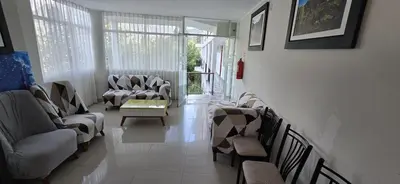 a living room with couches and a table and chairs at Hotel Los Andenes in Cotahuasi