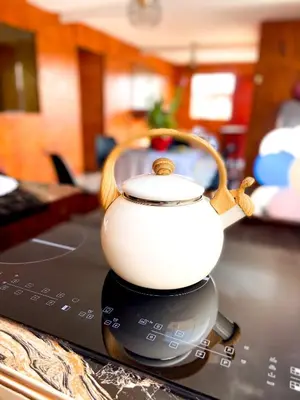 a tea kettle sitting on top of a laptop computer at Las Delicias in Huacho