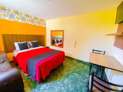 a hotel room with a bed and a table at Hostal Mayra Breña in Lima
