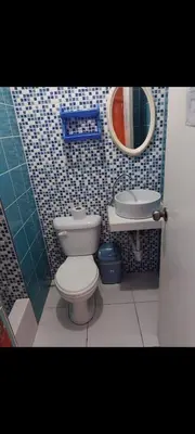 a bathroom with a toilet and a sink at Hospedaje Puerto Escondido in Pucusana