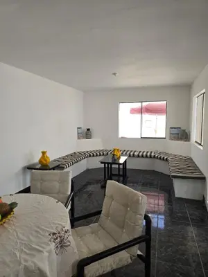 a living room with a couch and chairs and a window at Casa san Bartolo in San Bartolo