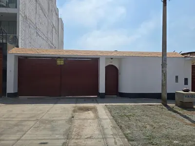 a garage with two brown garage doors in a building at Casa san Bartolo in San Bartolo