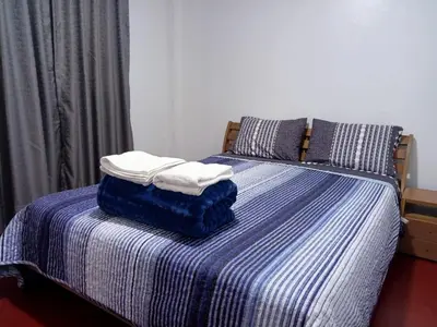 a bed with two towels on top of it at Departamento habitación cama king in Lima