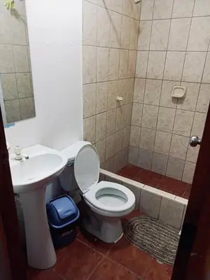 a bathroom with a toilet and a sink at Habitación cama queen in Lima