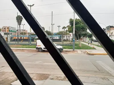 a view of a street through a metal fence at Habitación cama queen in Lima