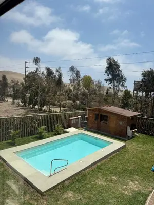 a swimming pool in a yard next to a house at Casa Hacienda El Triangulo - Asia del Campo in Asia