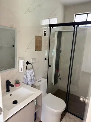 a bathroom with a shower and a toilet and a sink at Casa Hacienda El Triangulo - Asia del Campo in Asia