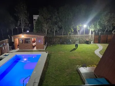 a backyard at night with a swimming pool at Casa Hacienda El Triangulo - Asia del Campo in Asia