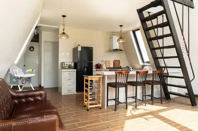 a kitchen with a staircase and a kitchen with a table at Casa Hacienda El Triangulo - Asia del Campo in Asia