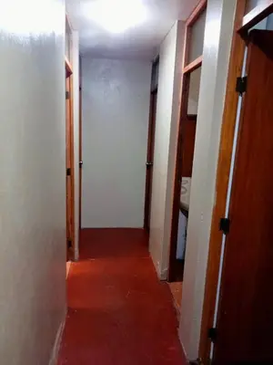 an empty hallway with two doors and a room with a hallway at Departamento de tres habitaciones amplio in Lima