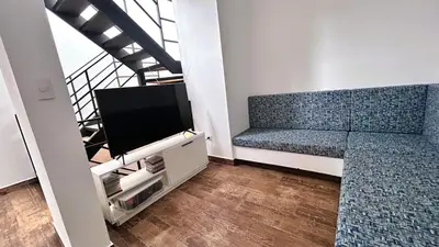 a living room with a couch and a flat screen tv at Beach house in Punta Hermosa, central beach area in Punta Hermosa