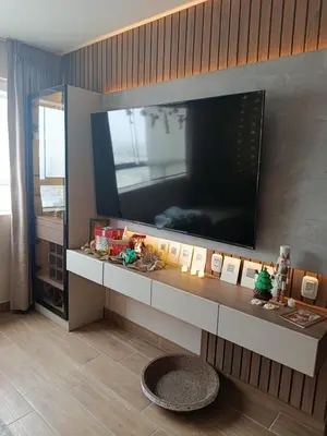 a living room with a large television on a wall at Apartamento amoblado in Lima