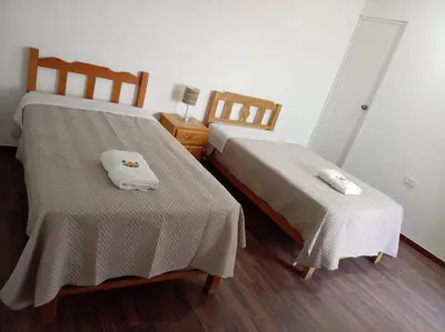 two beds sitting next to each other in a room at Mary 2 in Paracas