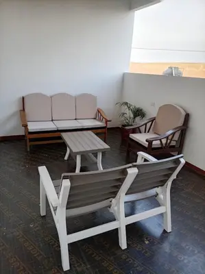 a waiting room with a bench and two chairs at Mary 2 in Paracas