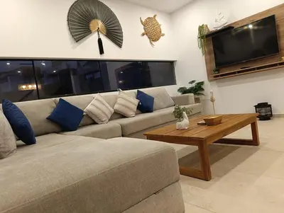 a living room with a couch and a coffee table at Casa de Playa a 15min del boulevard de Asia in Cerro Azul