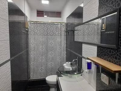 a bathroom with a glass sink and a toilet at Hospedaje Ocean Glips in Punta Negra
