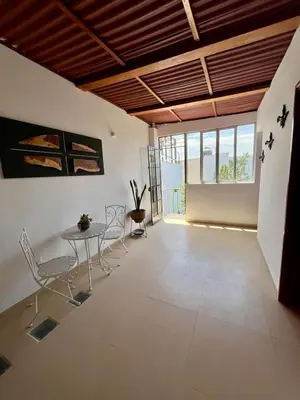 a living room with a table and chairs in it at Casa Cerezos in Ica
