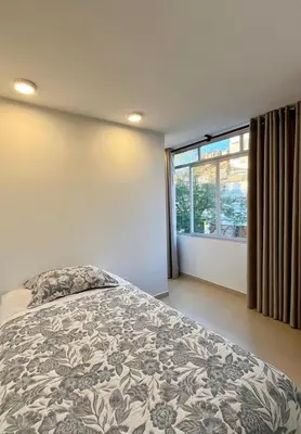 a bedroom with a bed and a large window at Casa Cerezos in Ica
