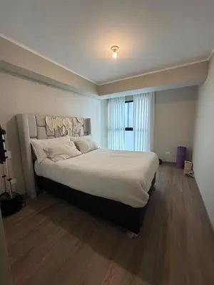 a bedroom with a large bed and a window at Cozy apartment, downtown area, fully equipped in Lima