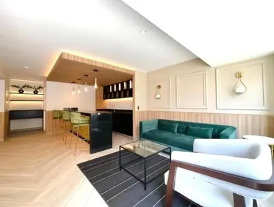 a living room with a green couch and a table at Cozy apartment, downtown area, fully equipped in Lima