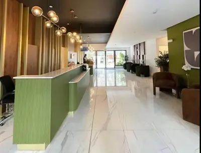 a lobby with a green and white reception counter at Cozy apartment, downtown area, fully equipped in Lima