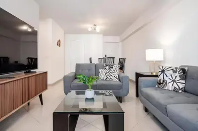 a living room with two couches and a tv at Bajada Balta Suites Spacious 3BR in Miraflores Walkable Area in Lima
