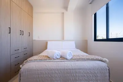 a bedroom with a bed with two towels on it at Sol de Paracas Beach Homes by Vibrant in Pisco