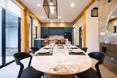 a dining room with a large table and chairs at Sol de Paracas Beach Homes by Vibrant in Pisco