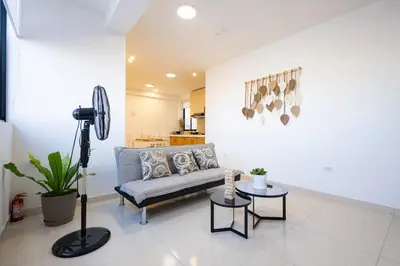 a living room with a couch and a table at Sol de Paracas Beach Homes by Vibrant in Pisco