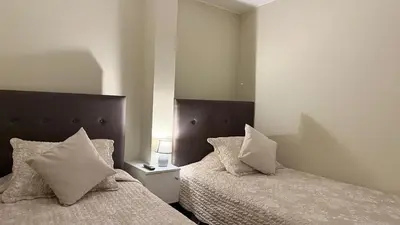 a bedroom with two beds with pillows at A2 cuadras de Larcomar - Miraflores in Lima