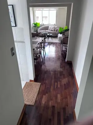 a hallway with a living room with a table and chairs at A2 cuadras de Larcomar - Miraflores in Lima