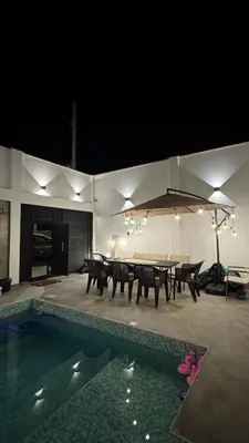 a patio with a table and chairs and a pool at Casa de estreno en Playa Los Lobos - Cerro Azul in Cerro Azul