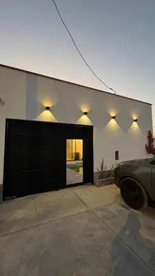 a garage with a car parked in front of a building at Casa de estreno en Playa Los Lobos - Cerro Azul in Cerro Azul