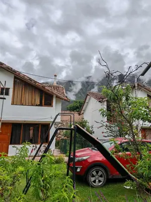 a red car parked in front of a house at UMAY lodge house in Urubamba