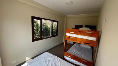 a bedroom with two bunk beds and a window at Welcome to our Pachacamac retreat in Pachacamac