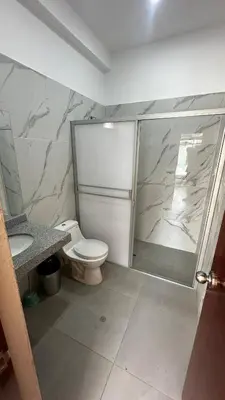a bathroom with a shower and a toilet and a sink at Welcome to our Pachacamac retreat in Pachacamac