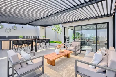 a living room with couches and a table and chairs at Saturn by Geko in Lima