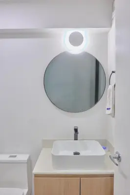 a bathroom with a white sink and a mirror at Saturn by Geko in Lima