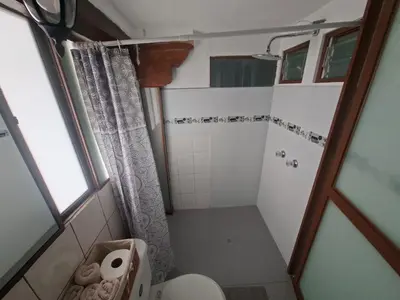 a small bathroom with a toilet and a shower at Acogedor Departamento Vitoque in Cusco