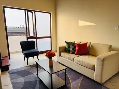 a living room with a couch and a table at M25 Duplex a media cuadra Embajada de USA in Lima