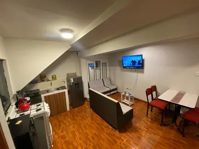 a kitchen and living room with a couch and a table at Cozy aparts & rooms in Cusco