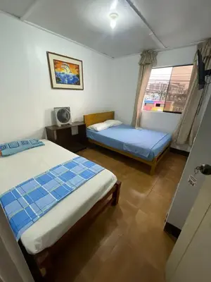 a hotel room with two beds and a window at HOSPEDAJE VISTA Del SOL PARACAS in Paracas