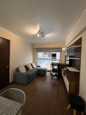 a living room with a couch and a desk at Moderno Departamento en Lima - Chorrillos in Lima
