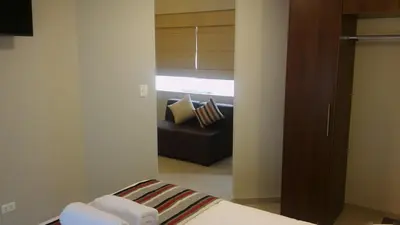 a bedroom with a bed and a couch in a room at Mauri in Huánuco